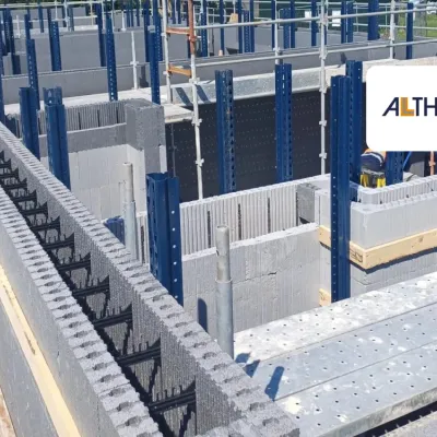 Construction site with insulated concrete form blocks and scaffolding in place.