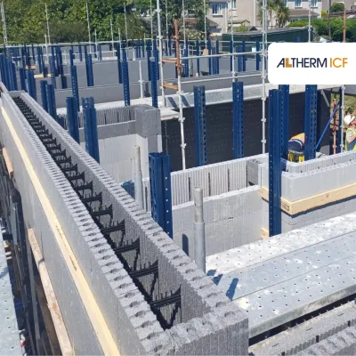 Construction site with insulated concrete form blocks and scaffolding in place.