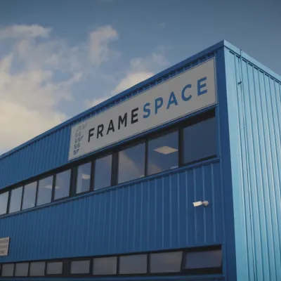 Large blue industrial building with "MARKETPLACE" text on its facade against a cloudy sky.