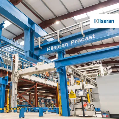 Blue industrial equipment in a manufacturing facility with "Elematic Precast" label.