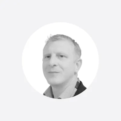 Black and white portrait photo of a middle-aged man in a circular crop.