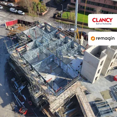 Aerial view of a construction site with scaffolding and steel framework, Clancy and Remagin logos visible.