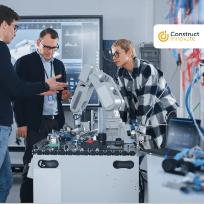 Group of people working with a robert at the lab