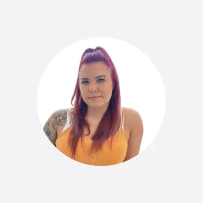 Woman with long red-brown hair wearing an orange top, circular cropped portrait photo.